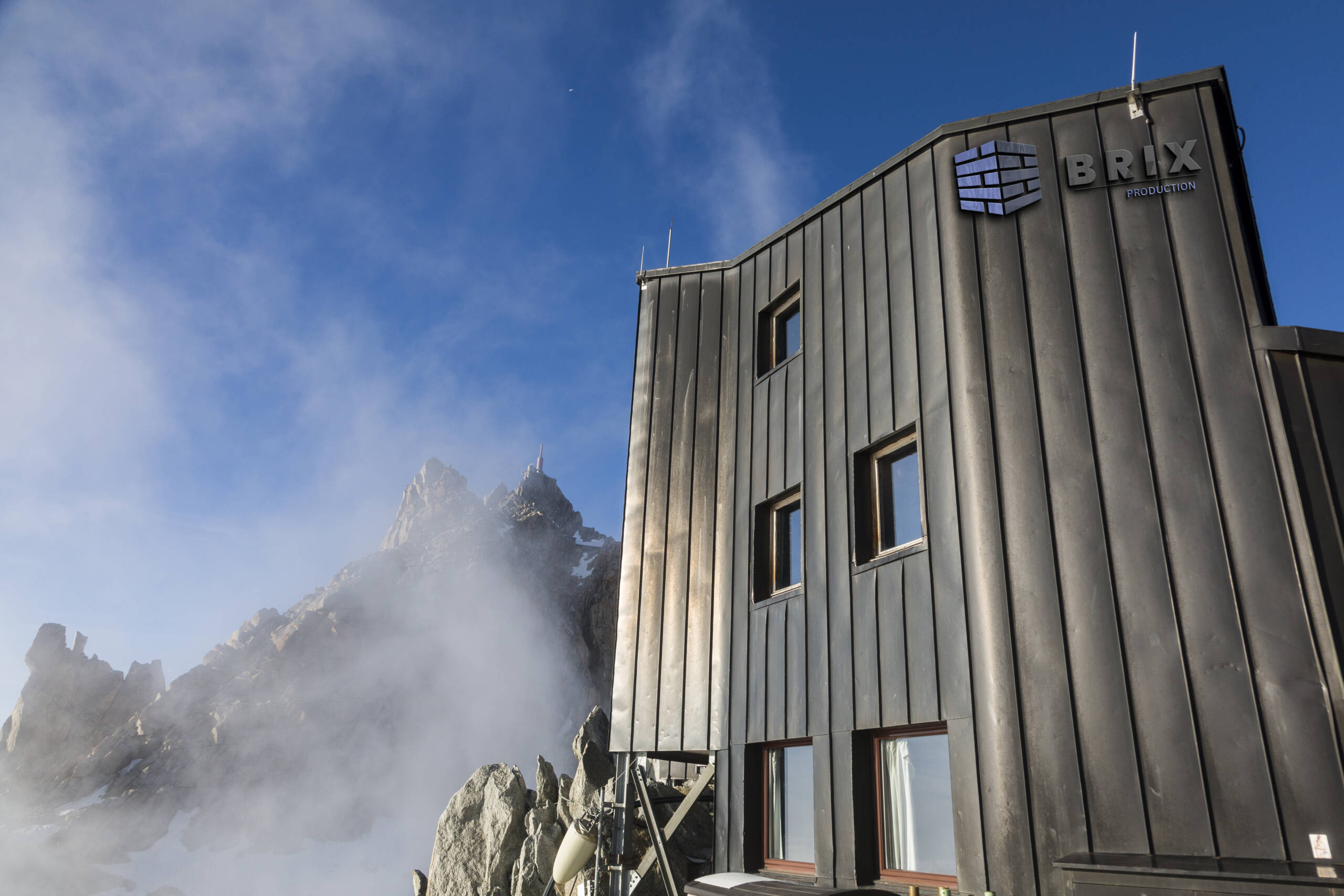 Part Cosmique refuge and view of Aiguille du Midi in the fog and clouds in the French Alps, Chamonix Mont-Blanc, France